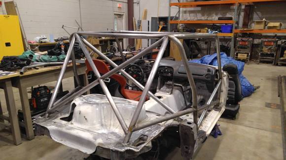 Cage nearly finished. Test fitting the dash over the dash bar and preparing to make the harness bar around the seat.