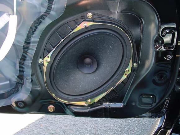 Not my picture, but since my car came with the Bose sound system, it came with 8" round speakers. The base model uses these adapter mounts to fit 6x8 speakers in the same place.

If I have the space with my flat door cards, I'd like to find a set and use them to install aftermarket 6x8 speakers.