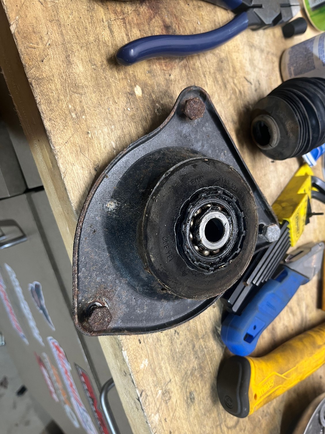 Rubber isolator in this strut bearing has flattened from years of being pummeled with no bump stop.  Honestly I think it was just never installed, maybe someone got confused and thought these yellow Konis didn’t require a bump stop.