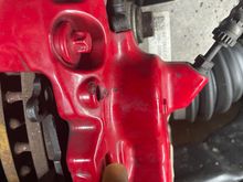 Pliers with a bit of plastic tube to keep from damaging the coating on the caliper 