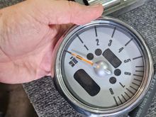 The tachometer is removed from the steering column by removing 2 T25 torx screws at the base.