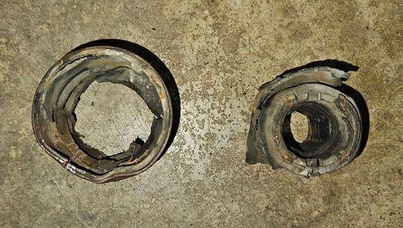 The old bushing pieces were pressed out of the bracket and pried off of the control arms.