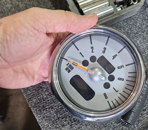 The tachometer is removed from the steering column by removing 2 T25 torx screws at the base.