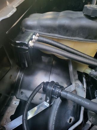 Davies Craig intercooler pump on custom bracket. Bracket replaces the battery tray and hold the overflow tank and this pump. 