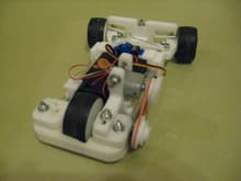 Here is the car I designed.  It used to have 4 wheels but one wheel in the rear works better.  Notice the front suspension with the C shaped 3D printed springs.