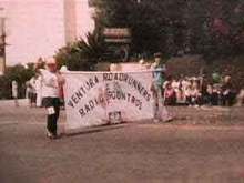 Venrura County Fair Parade. Tommy Douglas and Troy Flick carry s the Ventura Roadrunners Club Banner. 1981