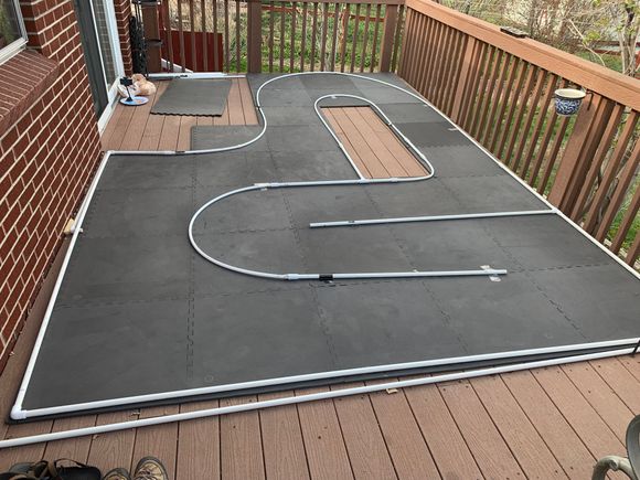 Under $100 Covid track! Harbor freight tiles and PVC. I can’t recommend doing this outdoors, royal PIA to maintain!