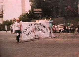 Venrura County Fair Parade. Tommy Douglas and Troy Flick carry s the Ventura Roadrunners Club Banner. 1981