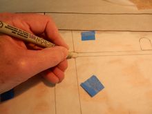 Blue tape over triangle cut-outs keep tracing in register. Fine marker used to tranfer reference marks to junction points on wing surface beneath.