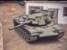 USMC M60 with aftermarket "era" panels for the front, sides and top of turret. Also a a more correct aftermarket M68 cannon. 