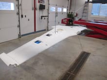 The wing is suspended to make painting both the top and bottom seamless.