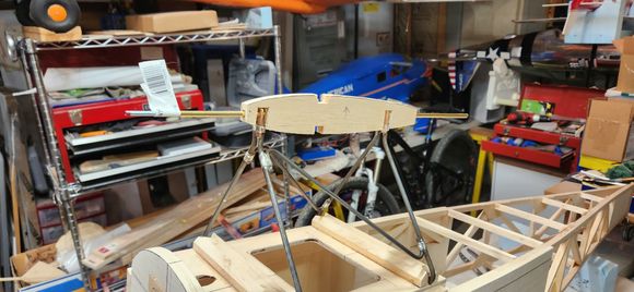 This center rib is a sandwich of ply and balsa with a brass tube thru the center that aligns and attaches the top wing.  The inner tube gets a threaded rod glued into it with a nut to hold the top wing on.  incidence and front to back alignment are double checked and cabanes are epoxied in their hardwood mounting blocks. the whole box will be epoxied when the wings are on just to double check alignment. 