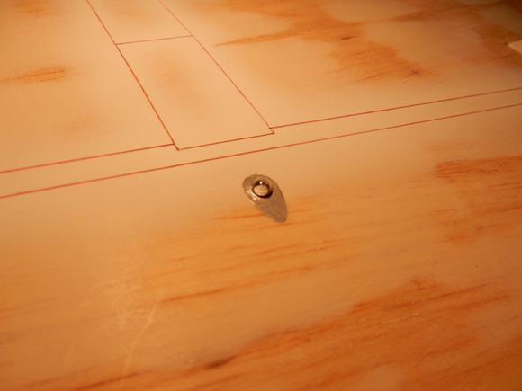 "Bulb" cemented in place in location. Inside top of dowel painted silver for effect. Surrounding wing area under blister painted aluminum.