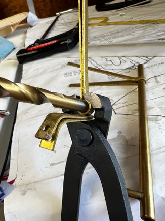 Using a Oetiker style crimp pliers, I was able to get a very nice bend around the drill bit.