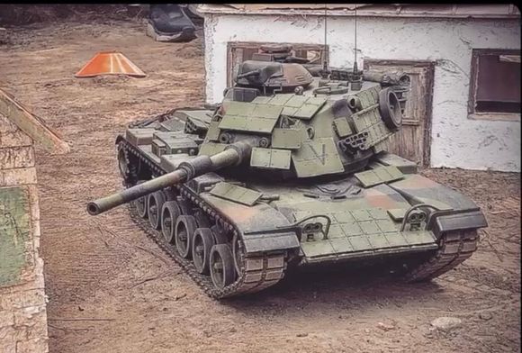 USMC M60 with aftermarket "era" panels for the front, sides and top of turret. Also a a more correct aftermarket M68 cannon. 