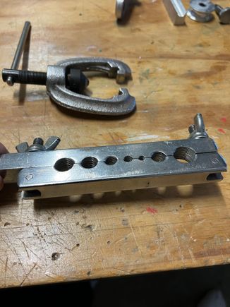 . . .   .by flipping the clamp over and using this non-beveled side tapping the flange perfectly flat.  It is at this point I fill with cerro, place the flange into the jig stop and make the bend.