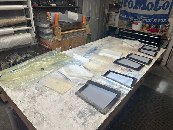 A table full of materials and molds for the flaps and rudder
