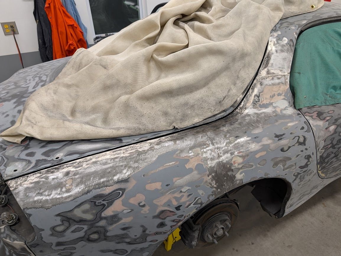 You can make out the original welds coming up from the wheel well and across the B-pillar