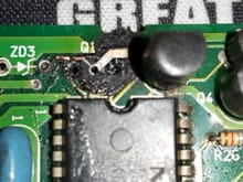 Damage to board, eyelets lifted on Q1, and broken solder runs.  A run is lifted under the IC chip that is supposed to extend to the lead (on left) of the transistor Q1.