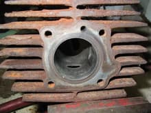 Rusty old  scored cylinder from lack of cooling around exhaust port ( the cylinder fins were full of dirt all the way around the exhaust port ..