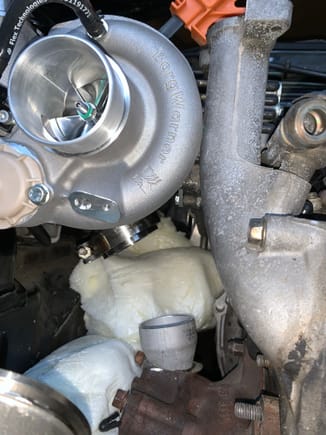 I was relieved once I got the secondary turbo here, enough room for a downpipe from the primary turbo to pass to the left.  You can also see the cut reducer in this picture, a small 45 or 60 degree 2" pipe will go between the reducer and the vband flange on the turbo.