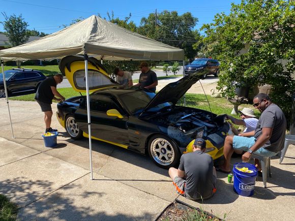 The whole crew at it peeling.  Yeah, we needed to move the tent for the front bumper guys.