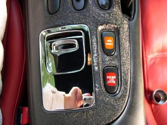 A nice contrast in materials with the metalized console painted wrinkle finish black next to the padded and black leather covered center console, the ashtray metalized and fully triple chrome plated inside and out and the fatted calf leather on the custom Spirit R seats.  (&quot;Metalized&quot; means the plastic was dipped in copper, then nickle, and then painted, while the ashtray was actually chromed.  The plastic is covered in 2-3 layers of real metal.) (Picture114)