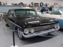 This car girl knew this vehicle was a 1961 Chevy without checking the sign