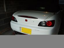 Red H badge