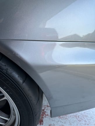 The scuff on the rear bumper, touch-up paint was applied. 