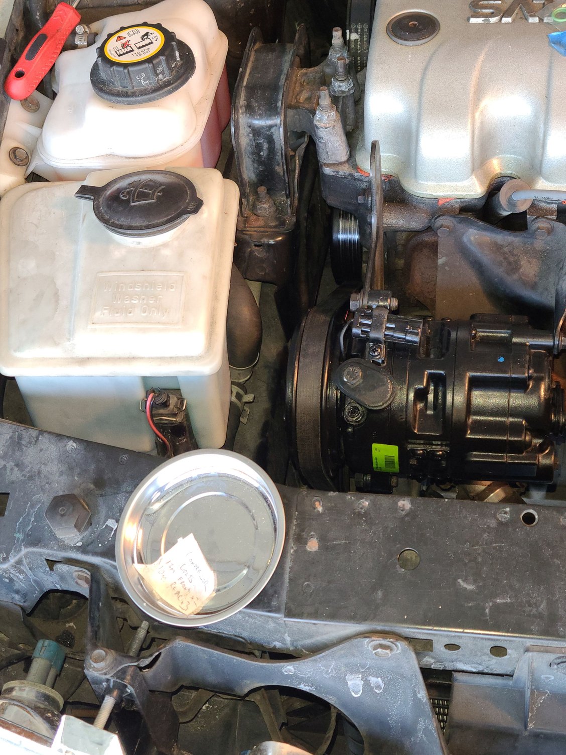 The belt drive is reinstalled onto the replacement compressor clutch.