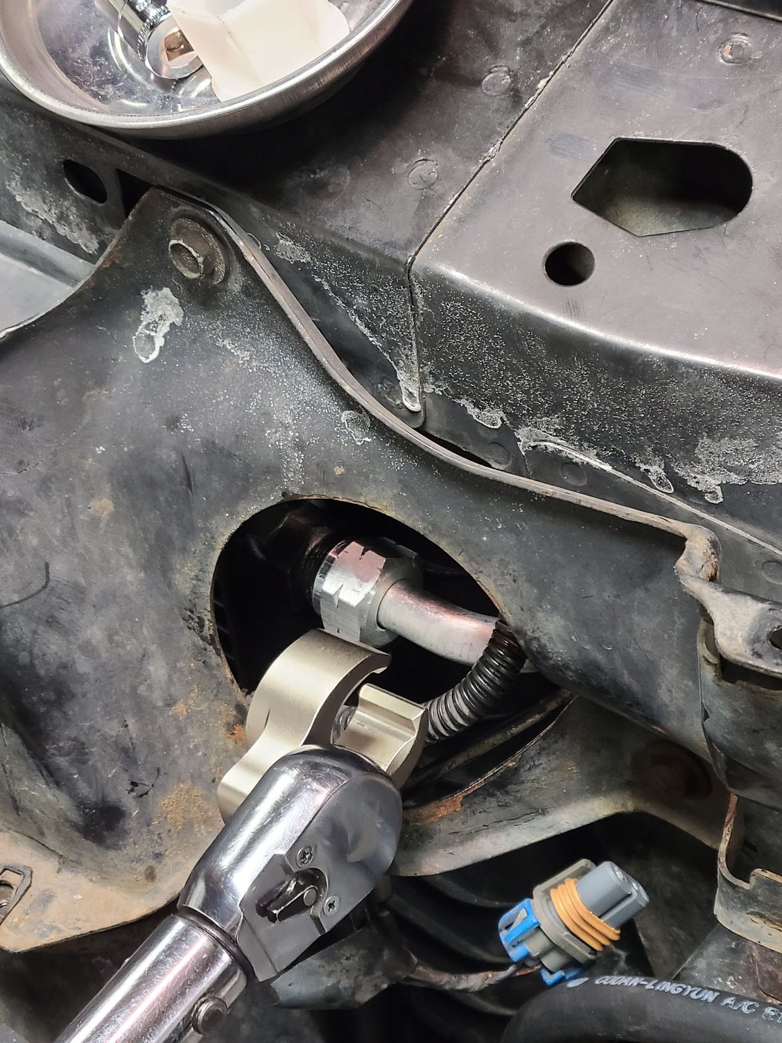 The new discharge hose is shown here connected to the condenser inlet