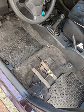 I bought the car used in Nov of 2021. The previous owner bent the jack bracket down. I don't know what these two pieces of metal are screwed to the floor are for. I'm guessing he had a replacement seat as well.