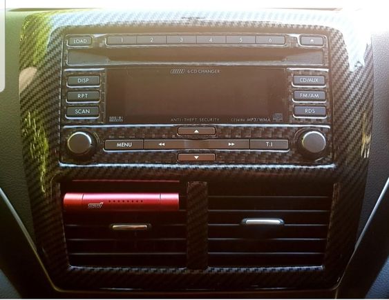 Carbon fiber wrapped stereo head unit.