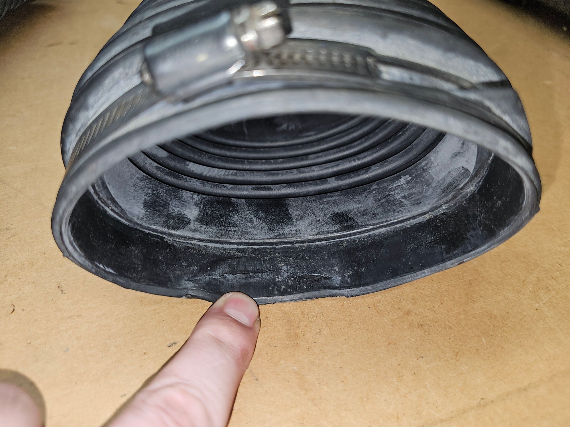 Torn boot right where my finger is pointing. Still seals just fine. 