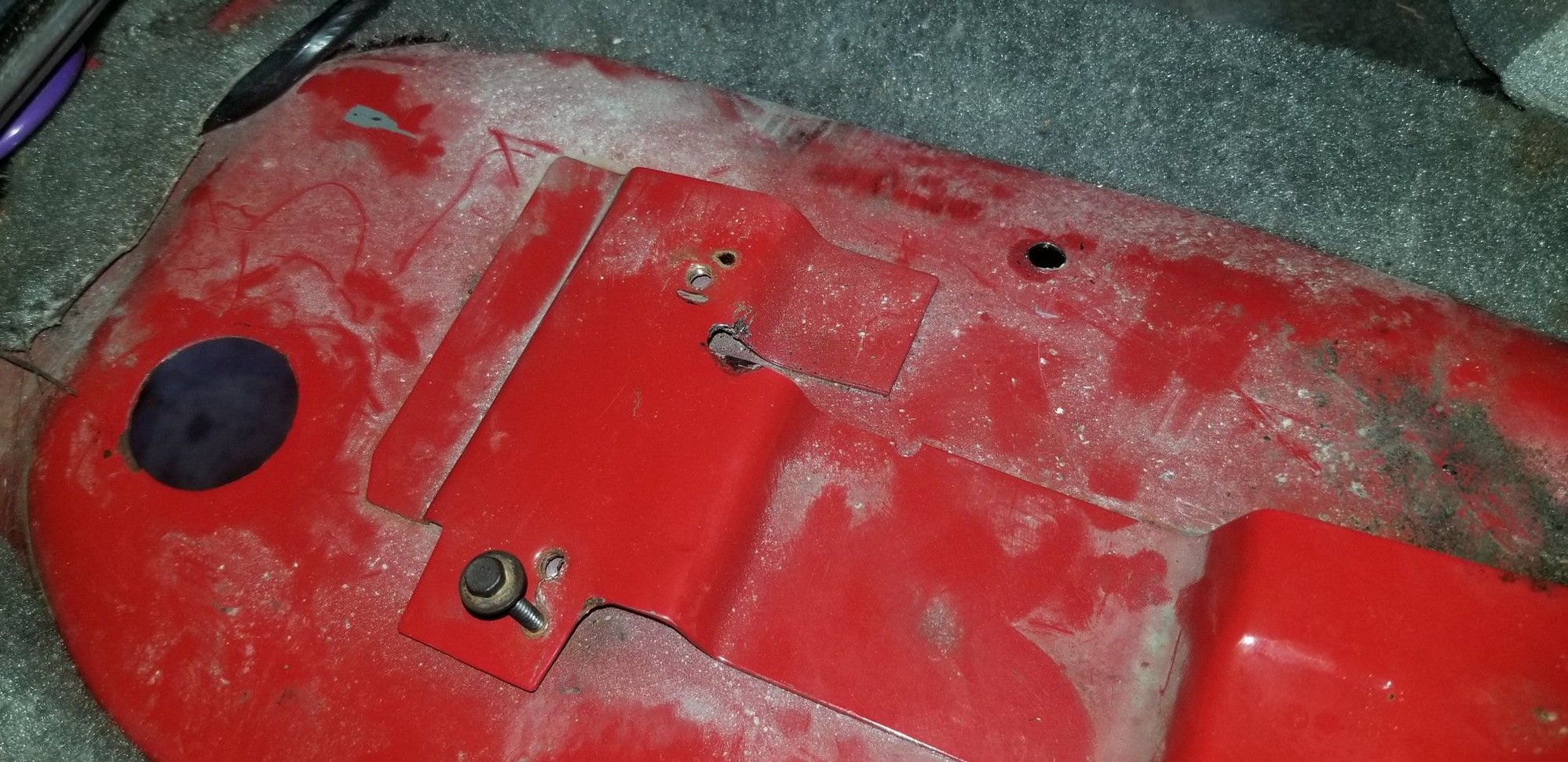 Here, you can see where the hole from the rear pass side bolt lined up, and the pilot hole was drilled 