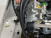 My Mustang has a high mount compressor.  Obviously this position makes it easier to make the required refrigerant lines.