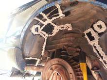 Back of passenger side rear wheel well after body sealant but before under coating.