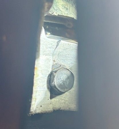 Bolt connects the track to the seat cushion bottom.