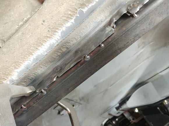 This is where the tricky welding comes in. The pinch welds are galvanized steel sandwiched between seam sealer. Makes for a SUPER dirty weld. I used the torch to burn off when I could, then shoved a ton of wire into it.
