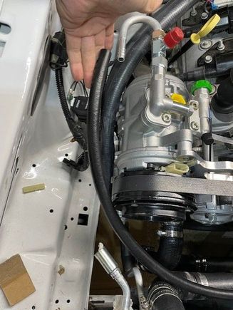 My Mustang has a high mount compressor.  Obviously this position makes it easier to make the required refrigerant lines.