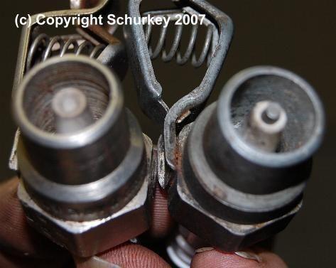 Recessed center electrode of HEI tester at left produces larger spark gap, vs. visible center electrode of ballast-resistor tester on right.