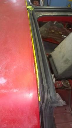 The trick to painting the T-Top opening without removing the weatherstripping:  Use a piece of nylon rope (about 1/4" dia.) and tuck it between the body and rubber to hold it up.  Then you tape off the rubber and paint.  Pull the rope out when the paint is dry and the weatherstrip will lay back down and hide the line.