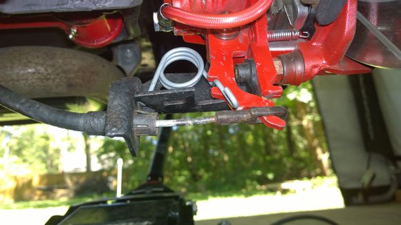 The little "hook" on this spring (13590527) doesn't interfere with the parking brake cable or eyelet.
