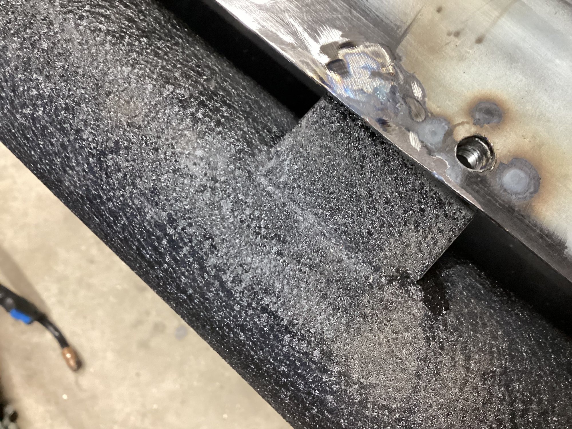 Capture nuts welded on the bumper for the two front mounts.