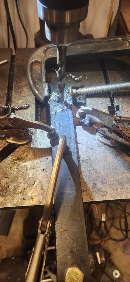 Now that i know how much i want my hangers to move exactly. Took the spring back out and unbolted the flat bars. I bolted them together and used C clamp to hold true with one another. Moved the hole 7/8 back from 11 to give me a spread on center of 10.125