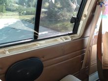 The trim runs under the sliding window and covers the bolts holding on the cap.