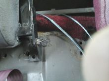 Here is the hinge after moving it in 4 or 5 inches.The floor contours in right where the hinge bolts to the floor, so i made a 1/4" thick spacer and welded to the hinge. The spacer was wide enough that I was able to use th seatbelt hole to bolt it dowm.