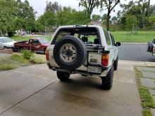 Custom made rear bumper and modified OEM tire carrier for high lift and raised spare up a few inches.  Running BJ-Spacers on the front and urethane spacers on 
 the rear. M95 Monotubes all around