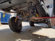 Got me 26 inch flex. Limitted  by linkage. I thought, hmmm... without the huge step of a long arm install and gas tank relocate, I think I can get another few inches out of this stock linkage mounting points. So after lots of time and another cringe worthy expense...  